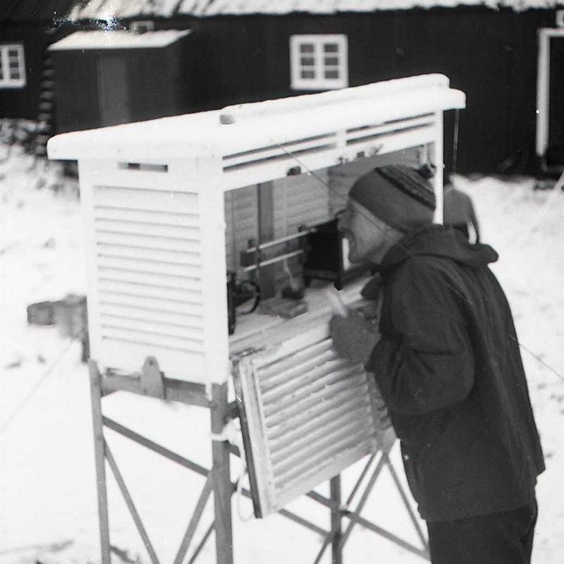 <p>Meteorological instruments being read inside a Stevenson screen in 1958 (Credit: © Brian Foote)</p>